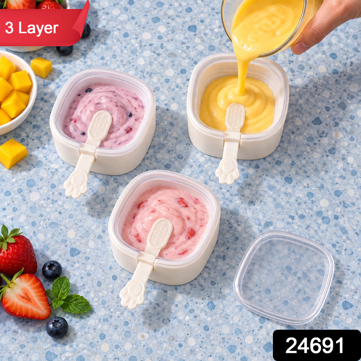 Three square molds with paw handles, filled with pink and yellow purees, one being poured. Strawberries and – view 10
