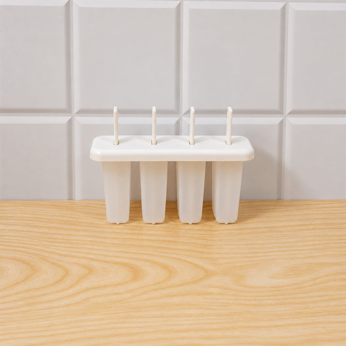 Various fruit ingredients arranged around the plastic 4-cavity popsicle mold