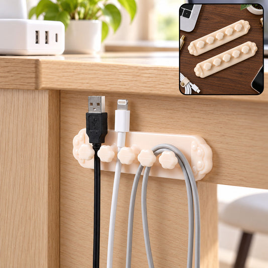 Beige flower-shaped cable organizer clip with five slots holding black, white, and grey cables under a wooden desk.