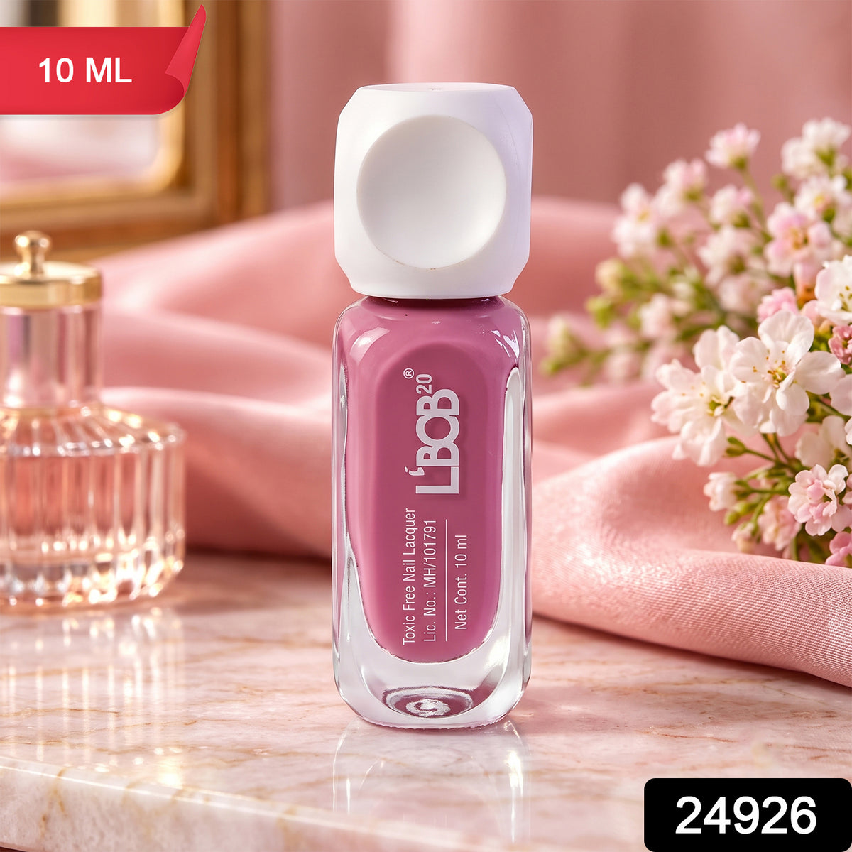 A small glass bottle of mauve nail polish with a white square cap sits on a pink marble surface. – view 2