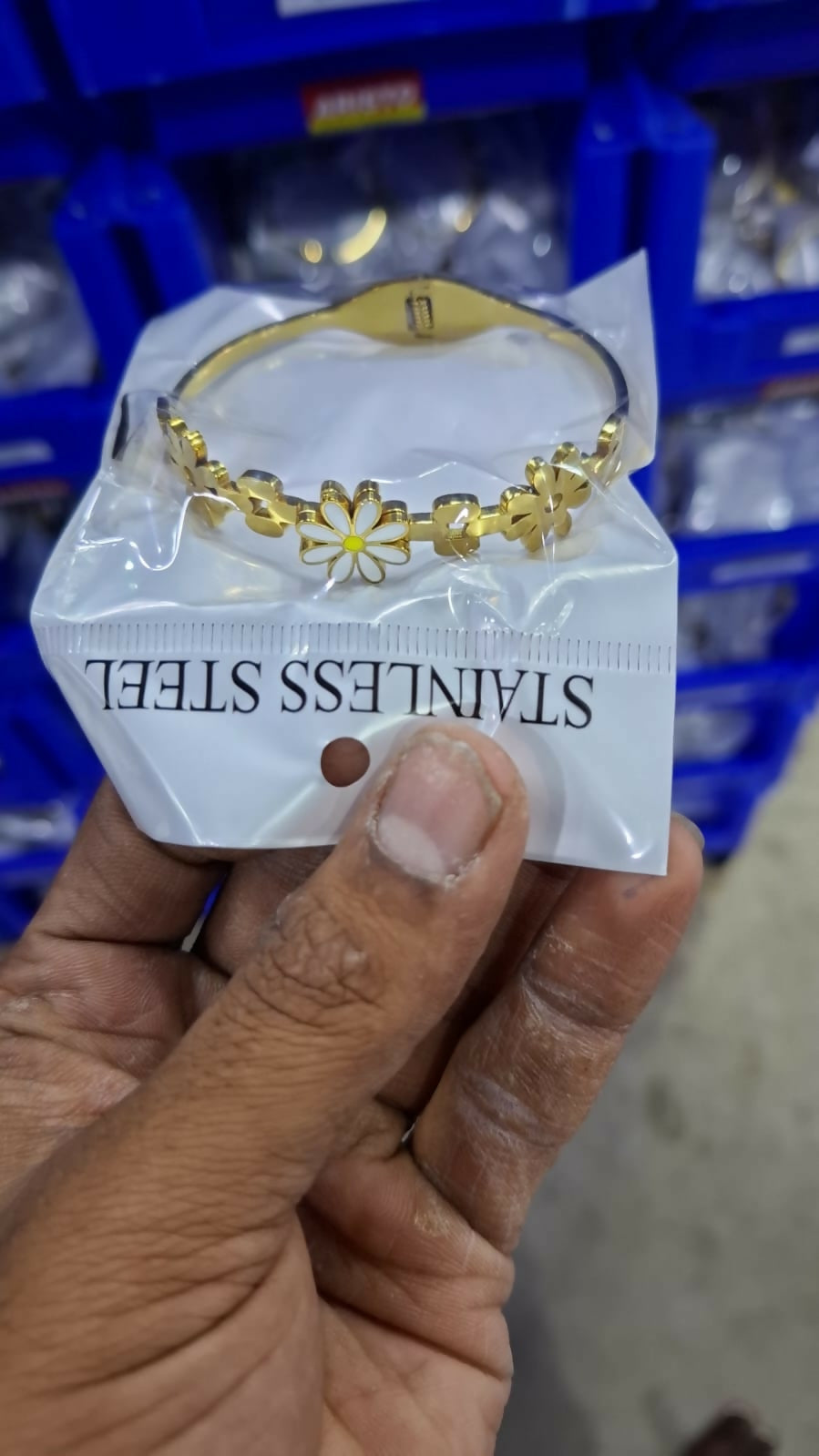 Detailed look at daisy motif with white and yellow enamel
