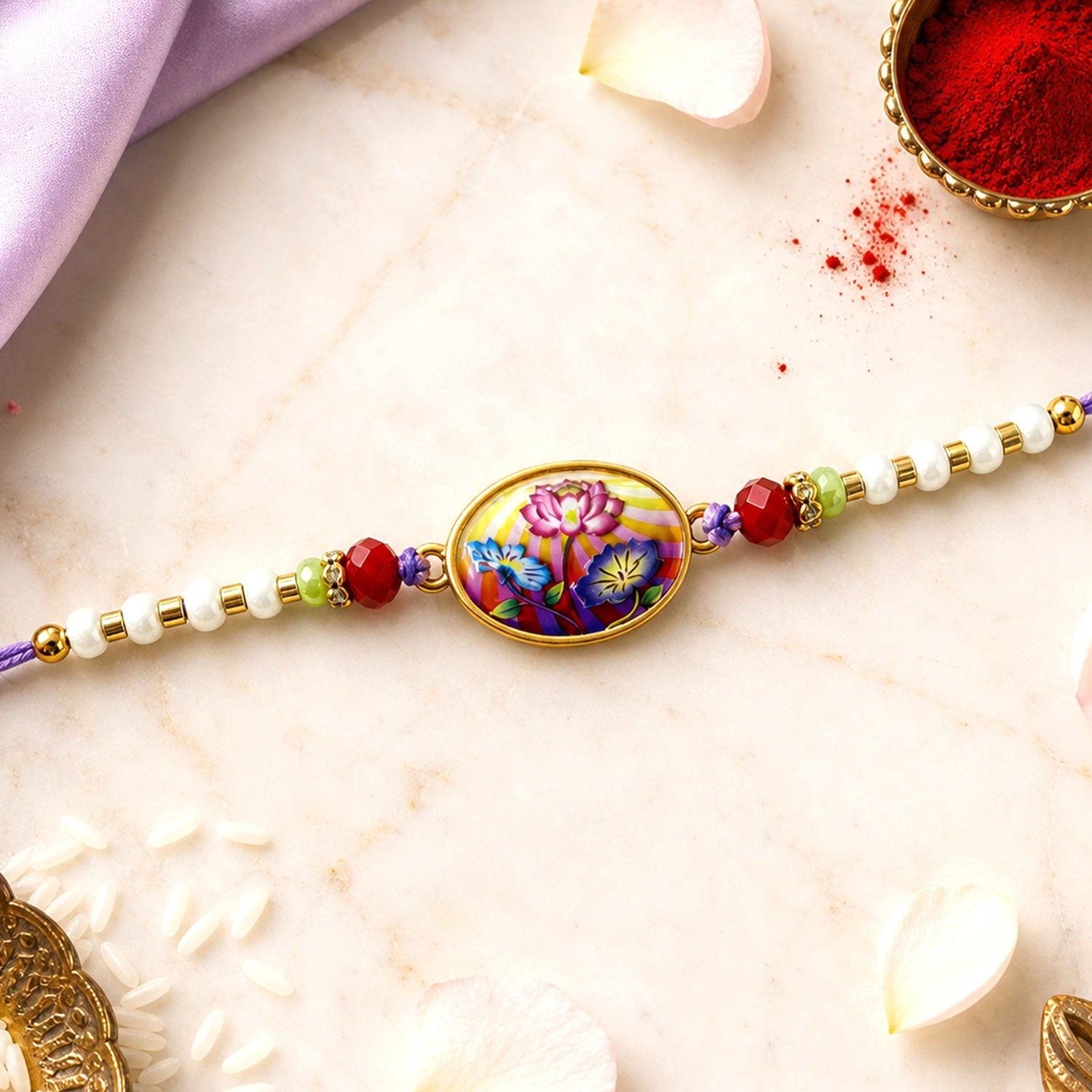 Floral Rakhi with purple thread, ready for Raksha Bandhan celebration