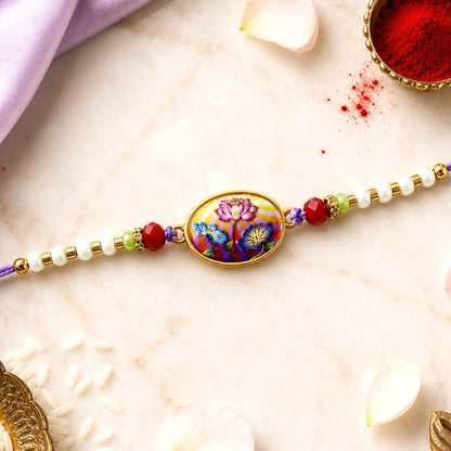 Floral Rakhi with purple thread, ready for Raksha Bandhan celebration