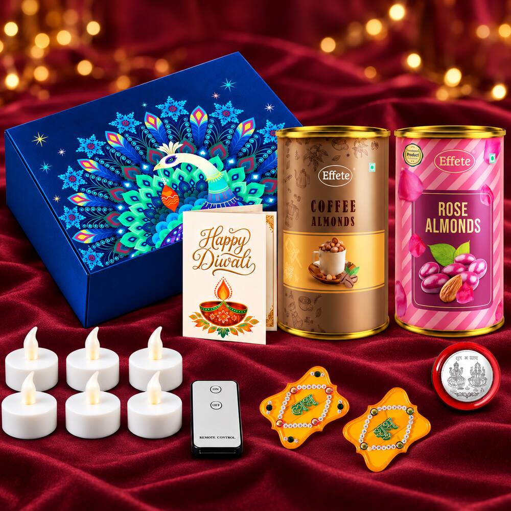 A collection of Diwali gifts including a blue peacock box, two almond tins, a card, LED lights, and yellow decor.