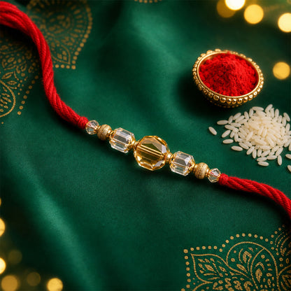 Red Thread Rakhi with Golden and Sparkling Crystal Bead Accents