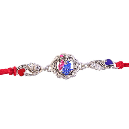 Silver-Toned Radha Krishna Rakhi with Colorful Enamel, Crystal Accents & Designer Red Thread