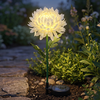 Solar flower LED stake light glowing in garden