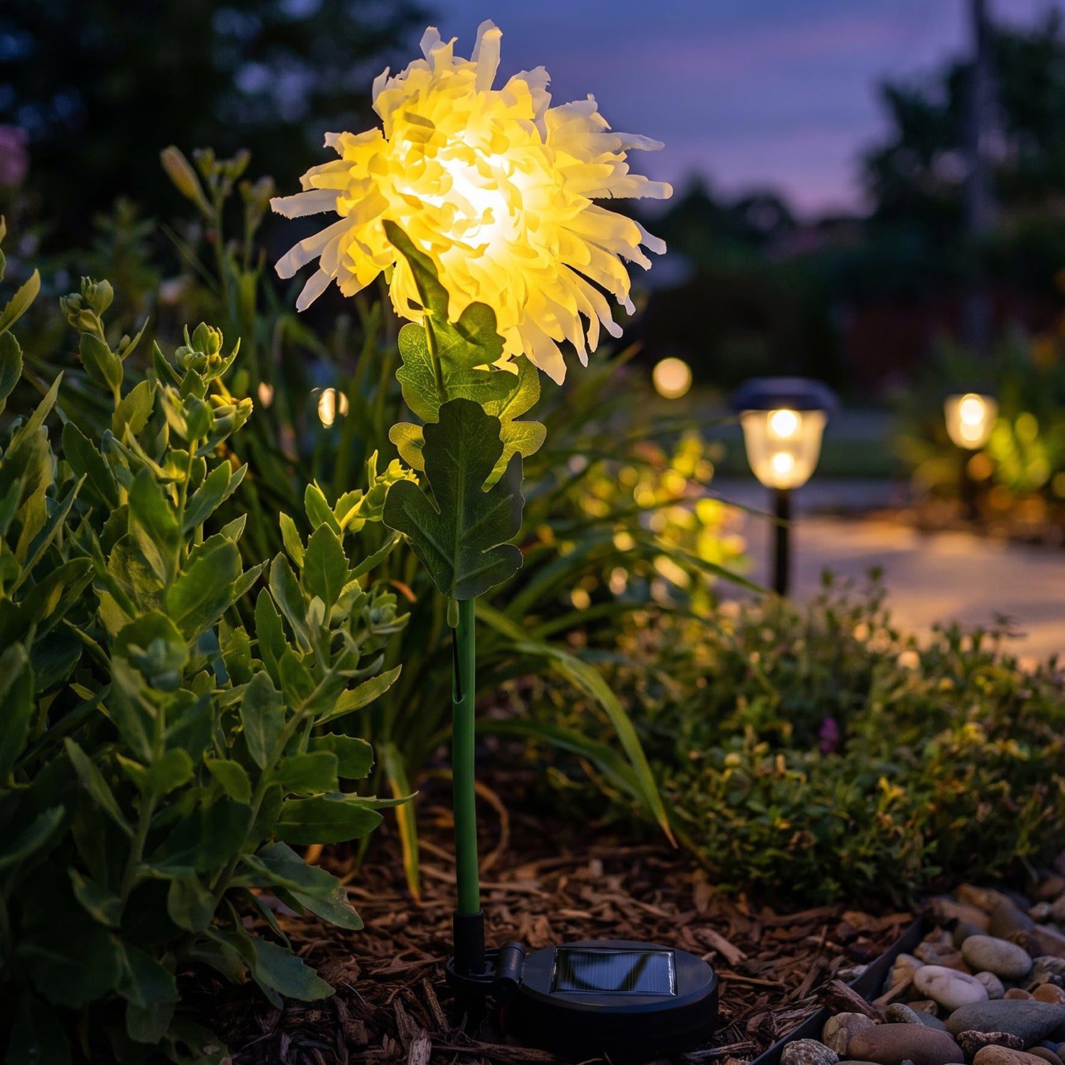 Warm LED flower stake light illuminating outdoor garden