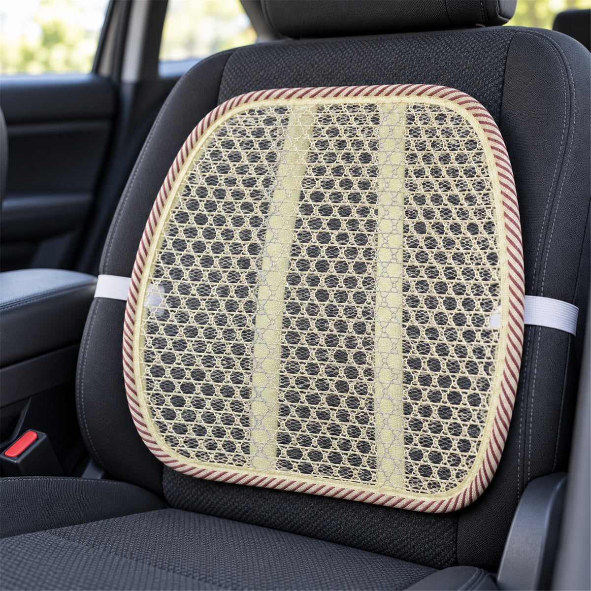 A beige mesh back support cushion with a red and white striped border is attached to a dark grey car seat with elastic