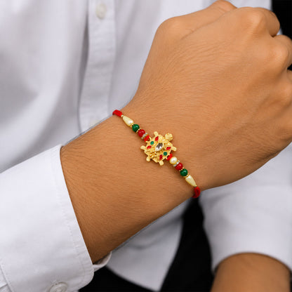 Close up view of the Turtle Rakhi showcasing its intricate craftsmanship and skin-friendly materials.
