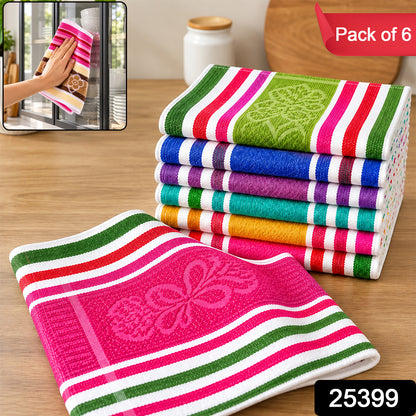 A hand holds a pink, white, green, and brown striped cloth with a floral pattern, next to a stack of six similar – view 2