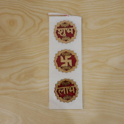 The three wooden Shubh Labh Swastik decorations are shown in clear plastic packaging on a light wooden surface.