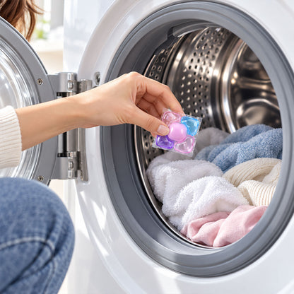 A single, colorful laundry pod is centered, surrounded by icons representing deep clean, stain removal, and fresh fragrance.