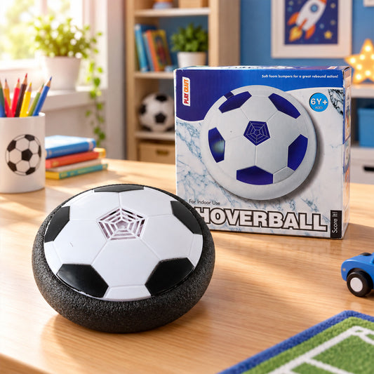 A white and black hoverball soccer toy sits on a wooden desk, with its product box in the background.