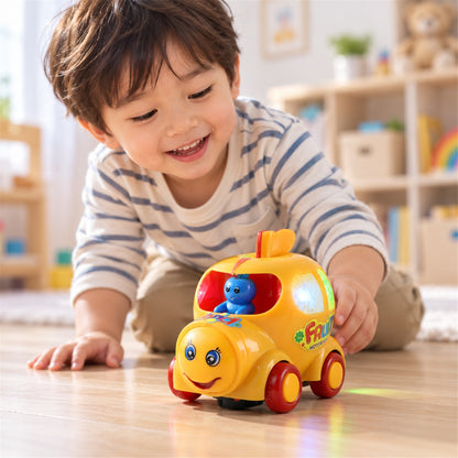 A young child with a striped shirt smiles while playing with a yellow musical car toy on a wooden floor.