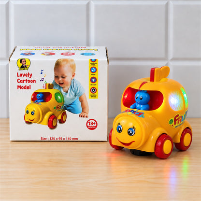 A yellow musical car toy with a blue driver and colorful lights sits on a wooden table next to its box against a white tiled