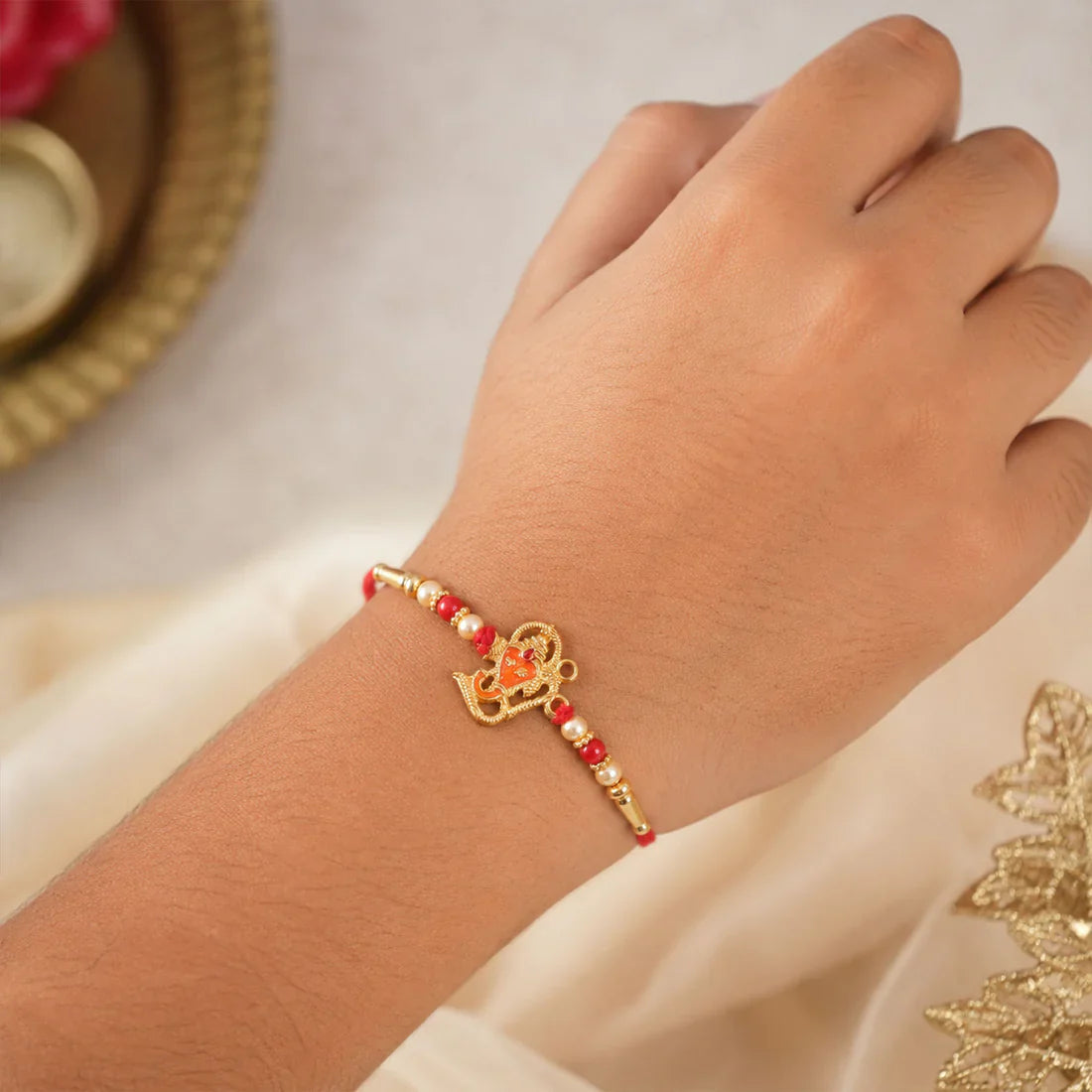 Shree Ganesh Rakhi displayed with traditional festive elements for celebrations.