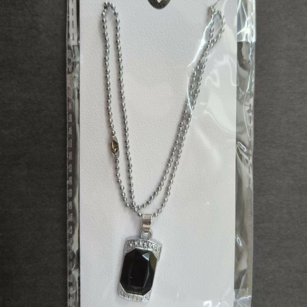 Model wearing elegant black onyx pendant necklace with crystal frame