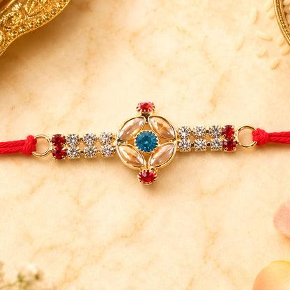 Traditional Rakhi for Brother with oval stone and gold beads on red thread, ideal for Raksha Bandhan.