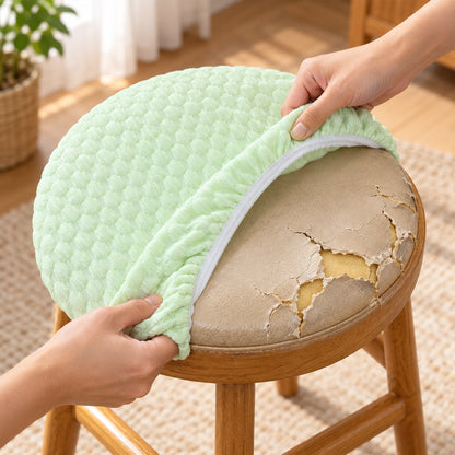 Hands removing a light green textured cushion cover from a distressed, peeling stool seat.