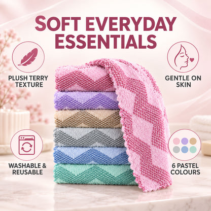 A stack of six pastel chevron-patterned face towels, with a pink towel draped over the top, on a light surface.