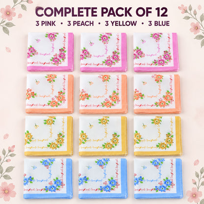Twelve neatly arranged folded handkerchiefs, three each with pink, peach, yellow, and blue floral borders, on a light pink