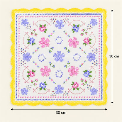 A white handkerchief with a yellow scalloped border and a detailed floral pattern is shown with measurements indicating