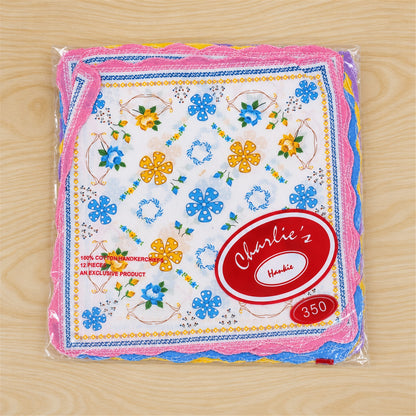 A clear plastic package contains multiple colorful floral handkerchiefs with scalloped edges, displaying a red brand label.
