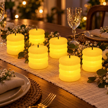 Six glowing ribbed flameless LED tealight candles arranged on a festive dining table with place settings.