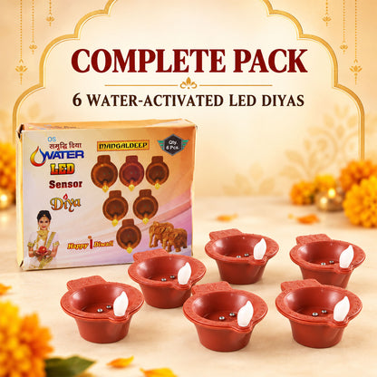 Six red water-activated LED diyas arranged in front of their product packaging box, surrounded by orange flower petals.