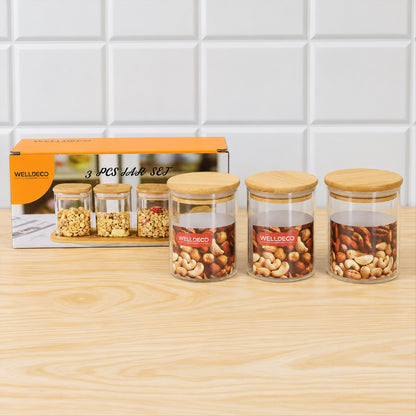Three glass jars with bamboo lids, two filled with nuts, next to an orange box displaying
