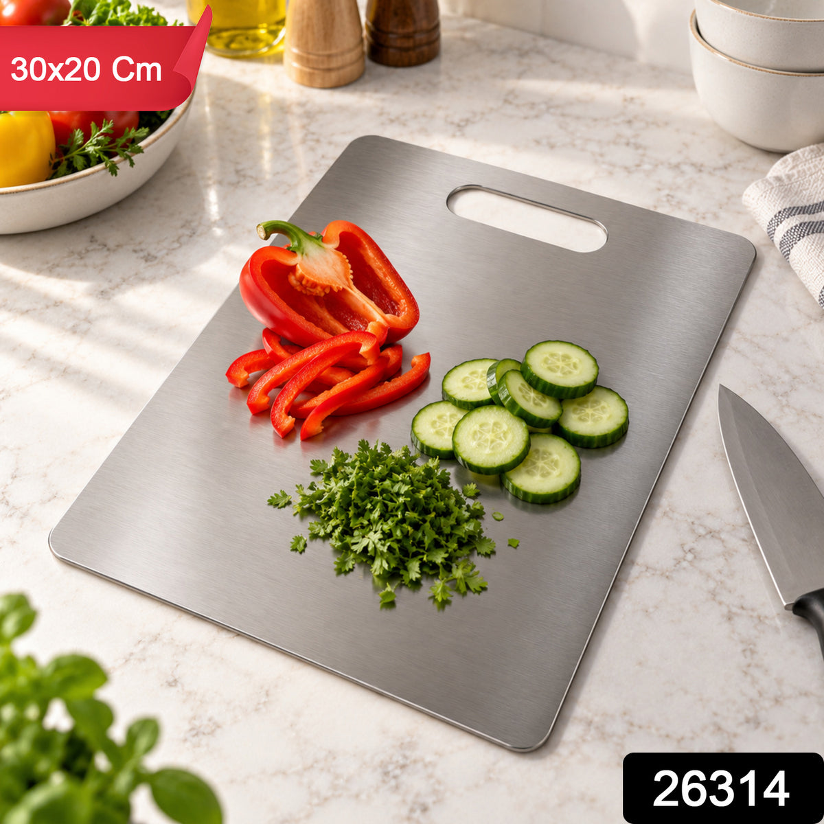 A silver cutting board with a handle slot, featuring chopped vegetables on a kitchen counter.