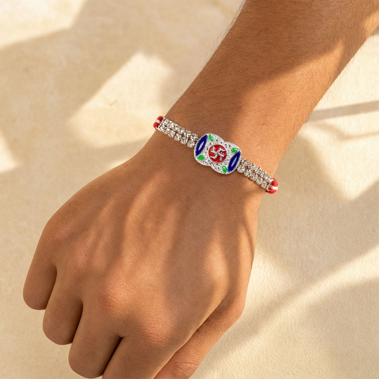 Premium Rakhi showcasing Swastik Charm, gold trims and chain look for Product Display