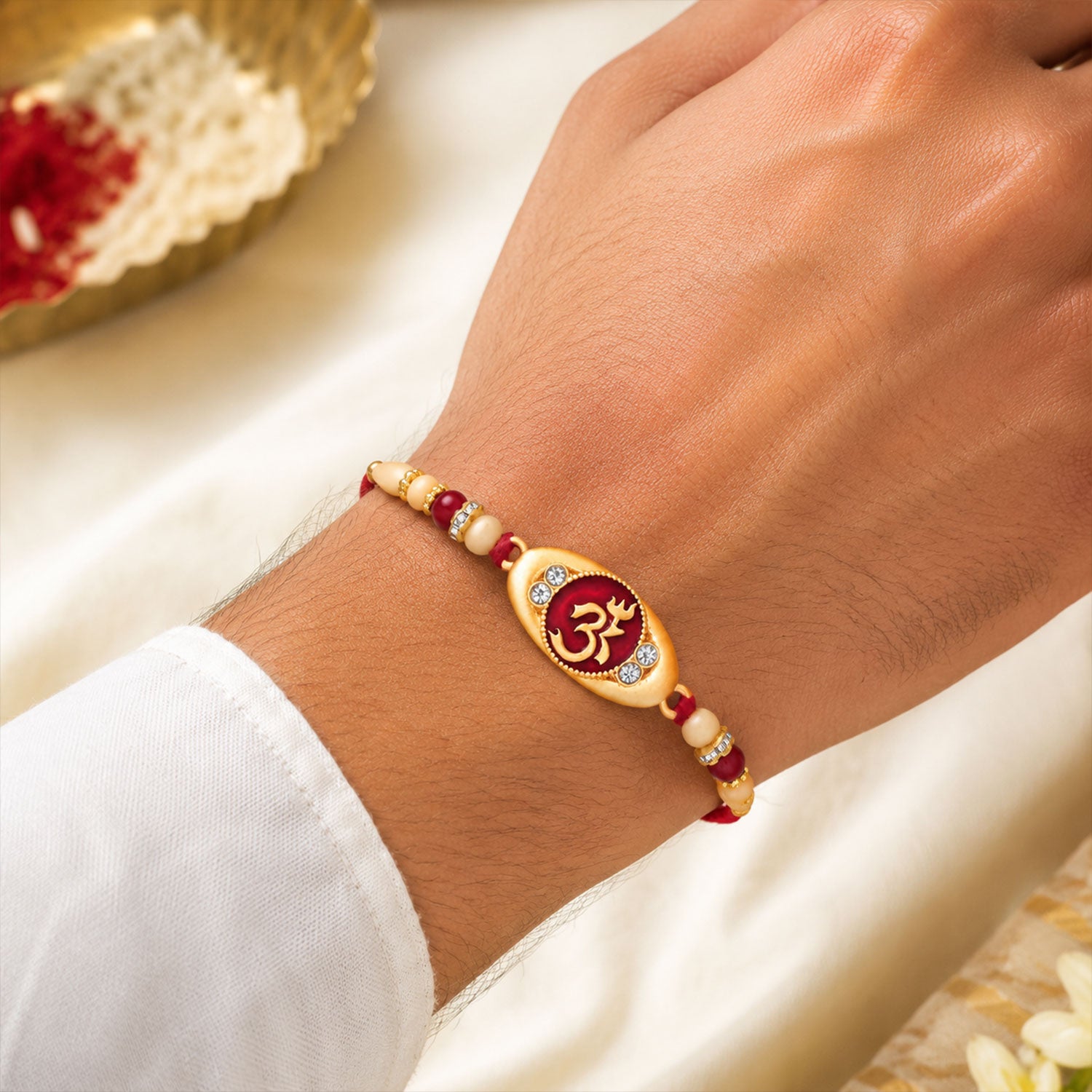 Side view of the elegant Spiritual Om Rakhi, showcasing its detailed design and comfortable thread.