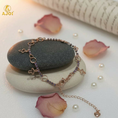 Rose gold crystal charm bracelet with delicate links and charms on wrist