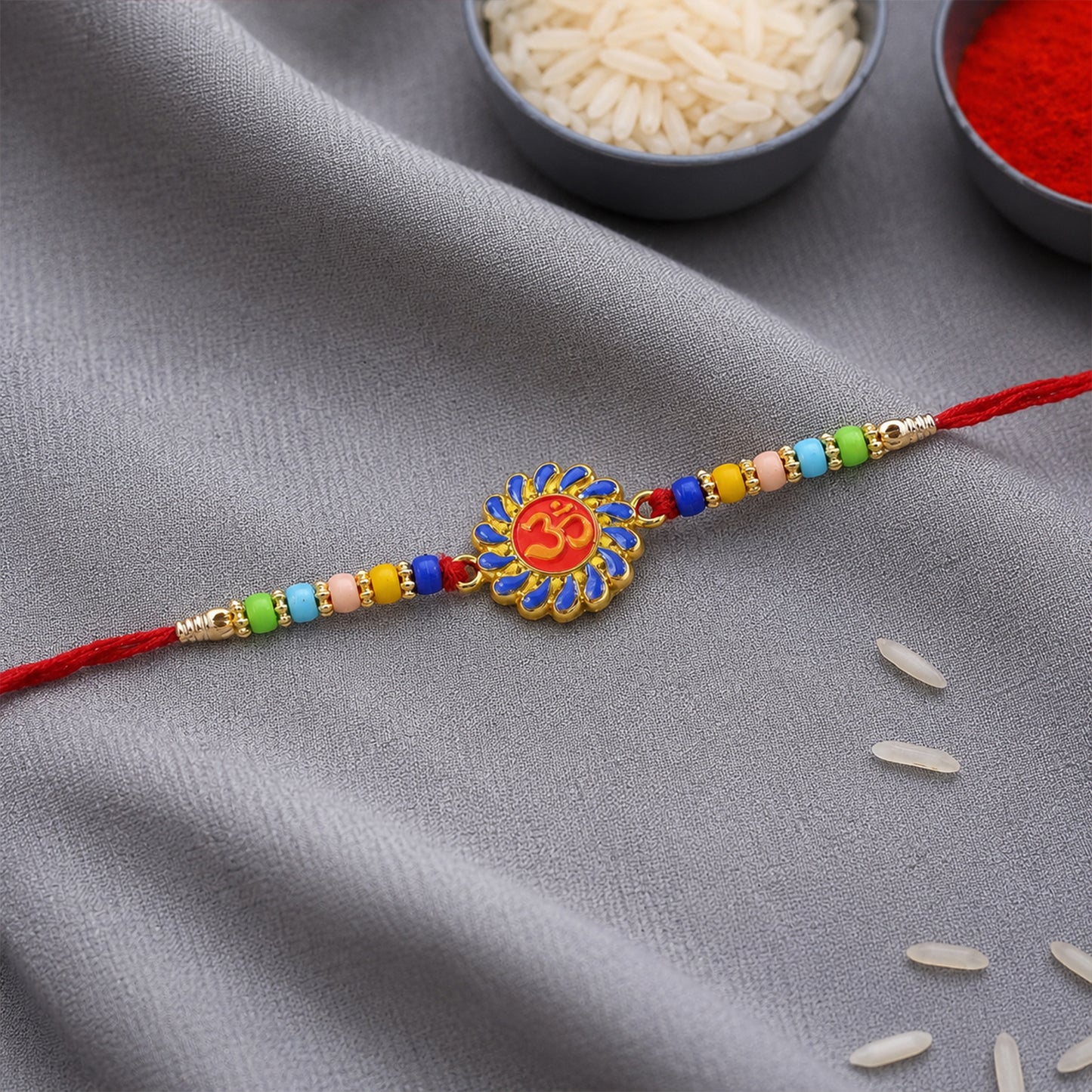 Om Designer Rakhi with multicolor beads on white background