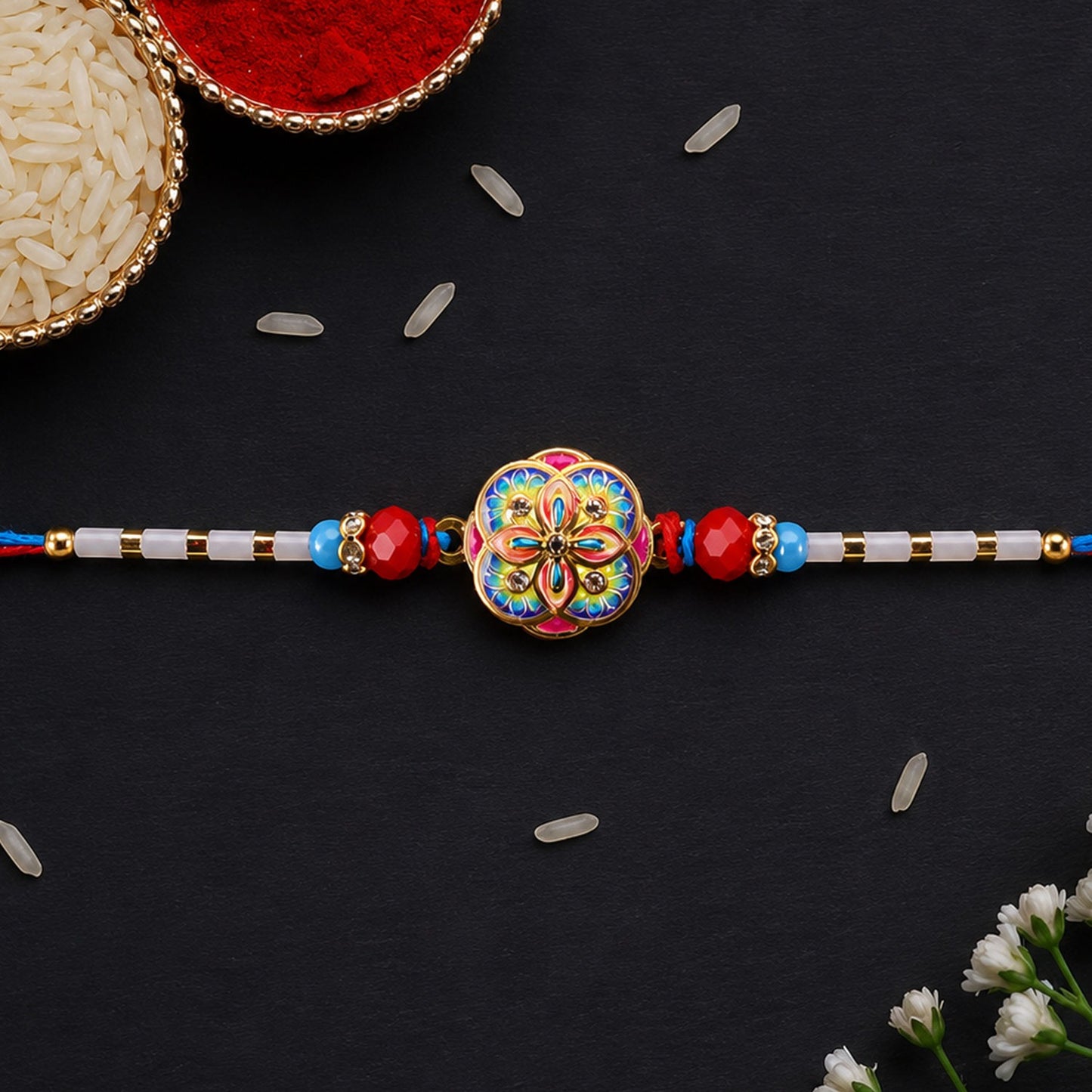 Colourful Kundan Rakhi with red beads and blue thread edges for Raksha Bandhan