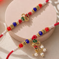 Divine Leaf Feather Motif Design Bhai Bhabhi Rakhi with Leaf Charm and Beads for Gift