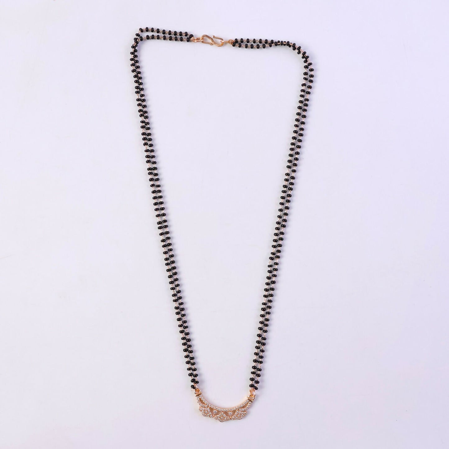 Close-up of CZ flower motifs on openwork floral pendant in rosé gold finish