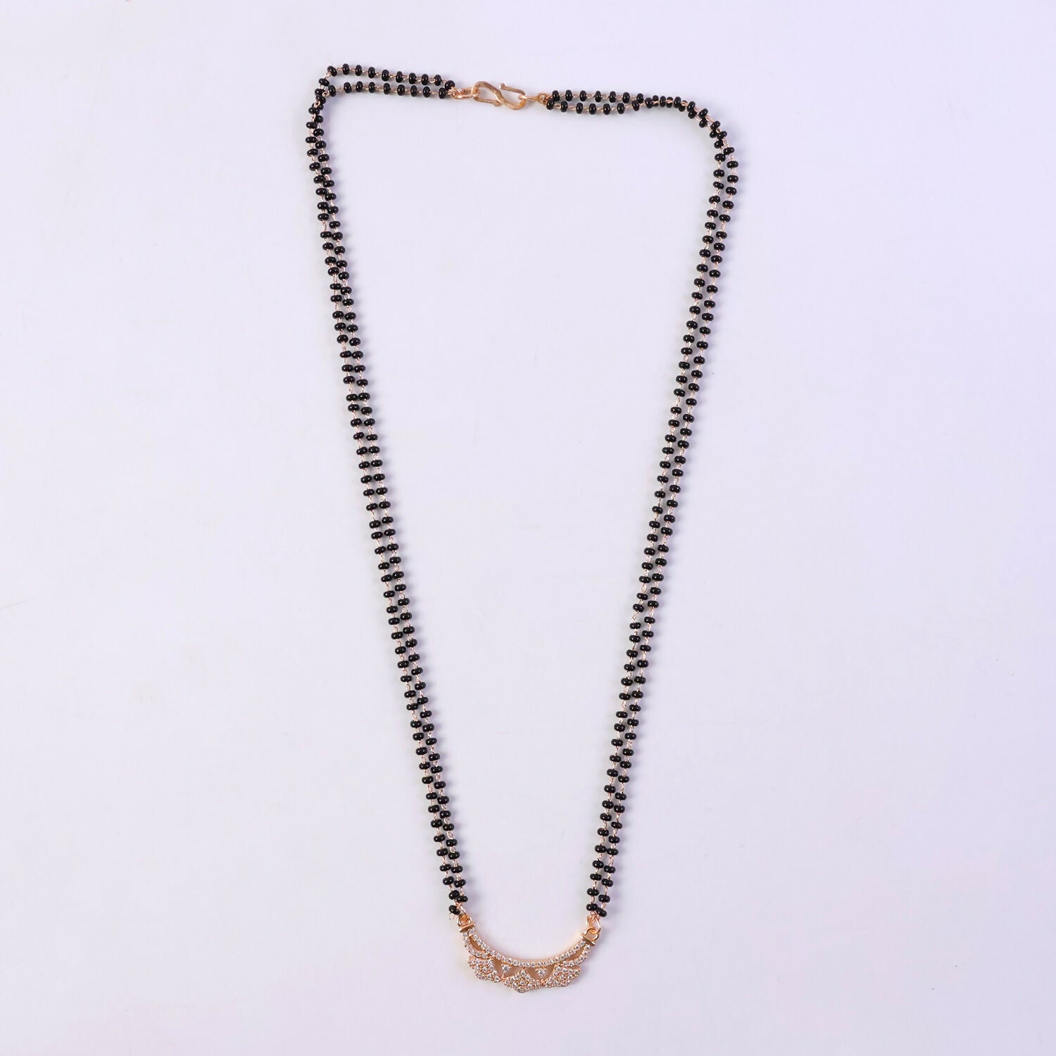 Close-up of CZ flower motifs on openwork floral pendant in rosé gold finish