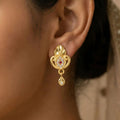 Gold Stud Earrings with Ethnic Floral Motif and Elegant Drop