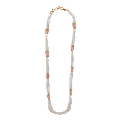 Layered strands of pearl beads with peach accents in traditional jewelry
