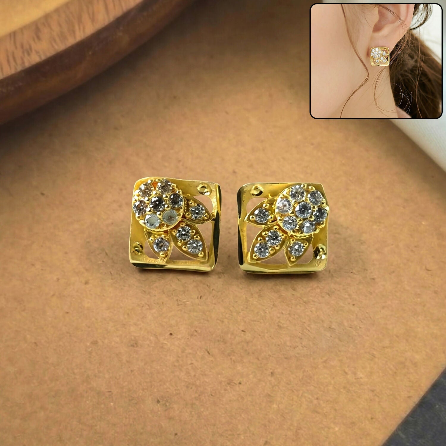 Close-up of classic round floral gold stud earrings with stone work