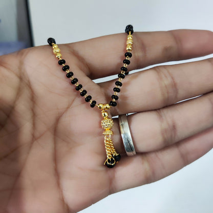 Woman showcasing black beaded mangalsutra jewellery