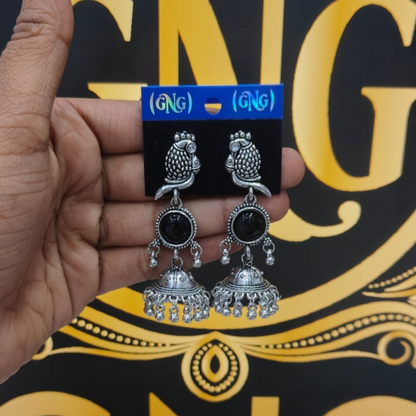 Oxidized jhumka earrings with black stone paired elegantly with ethnic attire