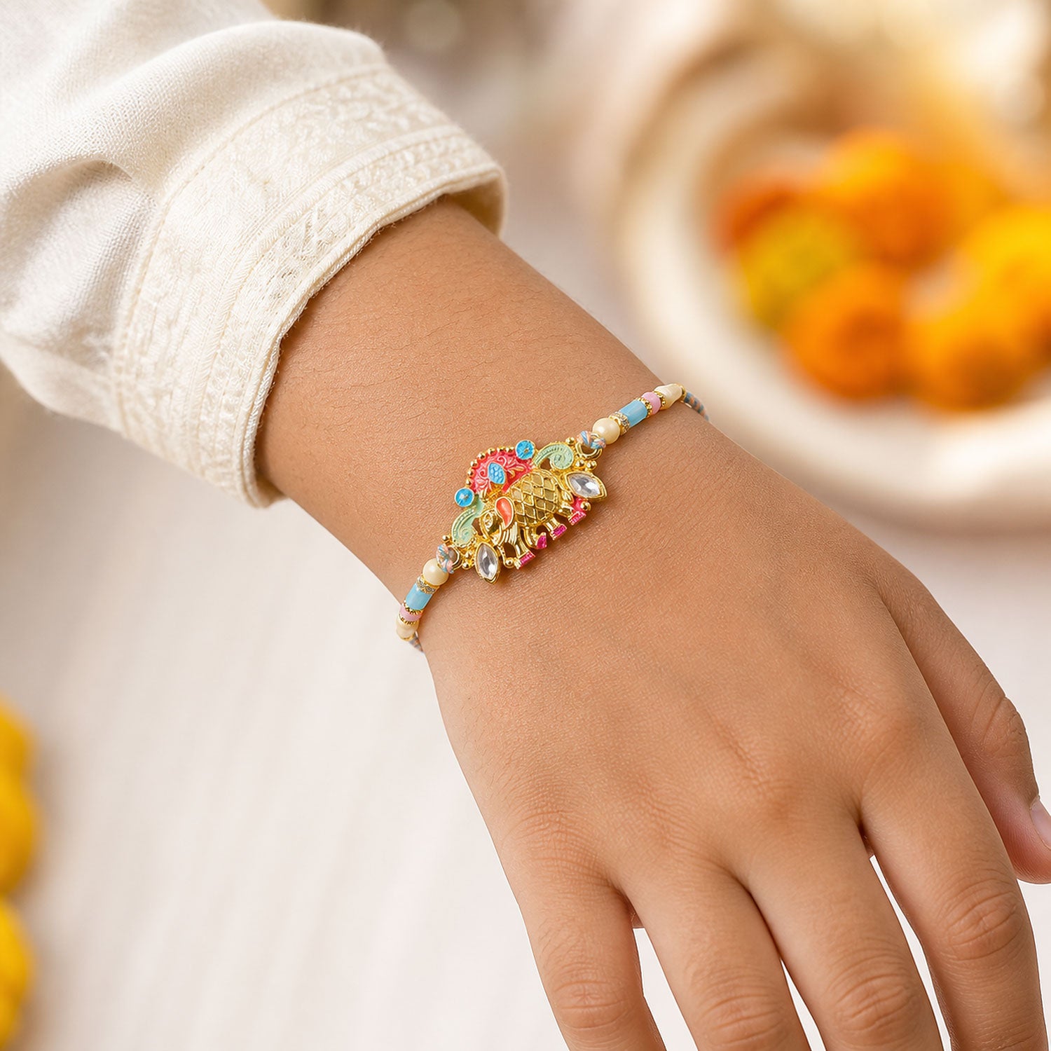 Textured Gold Elephant Pendant Rakhi with Multicolor Kundan