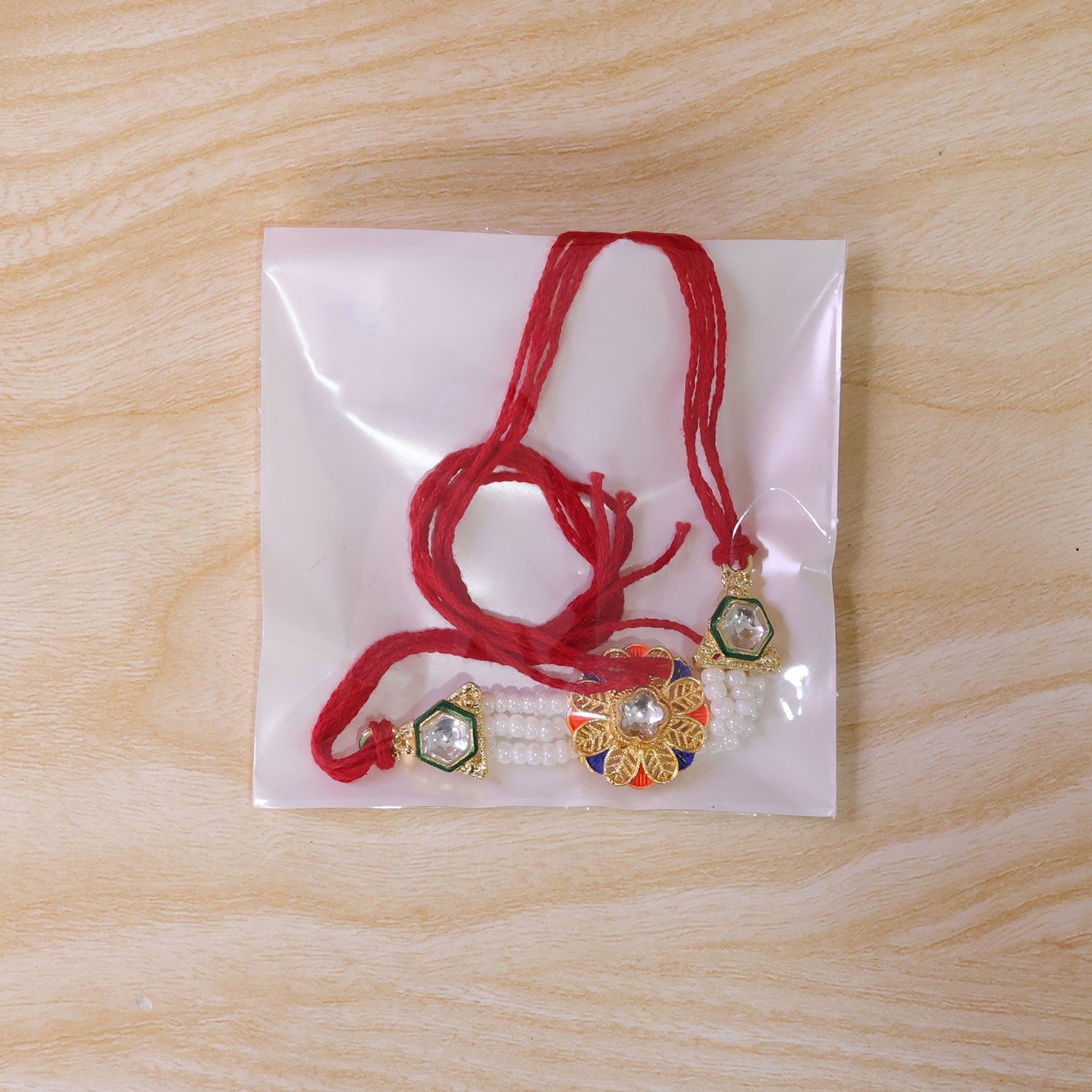 Pearl Flower Rakhi with Blue Yellow Details and Elegant Festive Brother Gift Styling