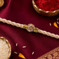 Cream Cord Rakhi with a Sparkling Floral Crystal Stone Pendant