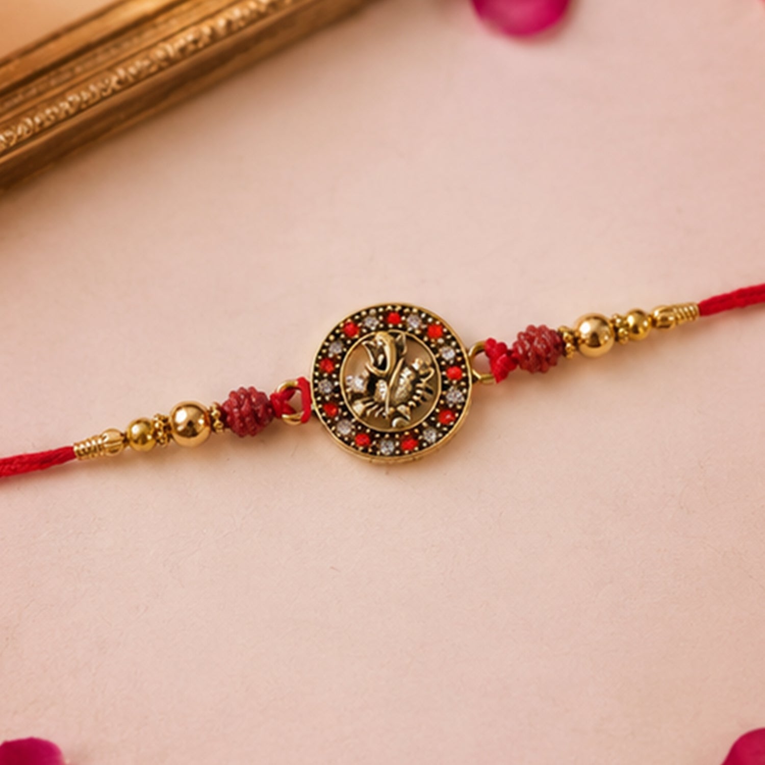 Golden Ganesh Rakhi for Boys with Red Thread and Rudraksha Beads