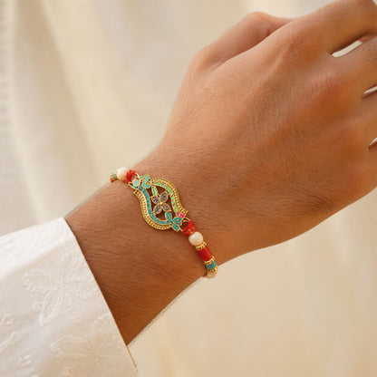 Golden Filigree Oval Floral Centerpiece Rakhi with Pink & Turquoise Enamel Detail